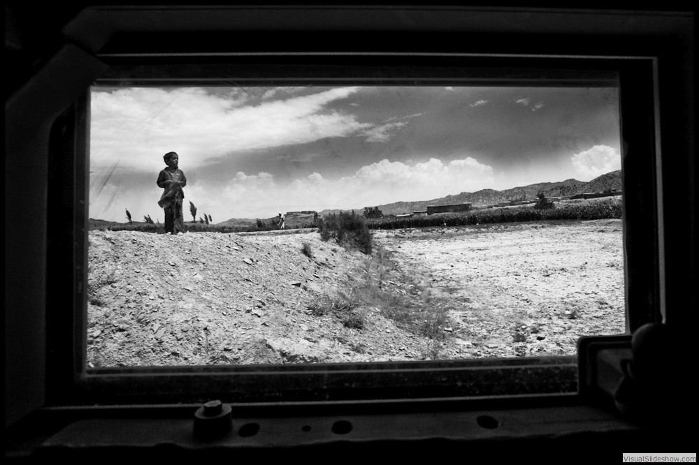 0035_zoriah-photojournalist-war-photographer_zoriah_photographer_afghanistan_war_tank_humvee_window_boy_photograph_photojournalist